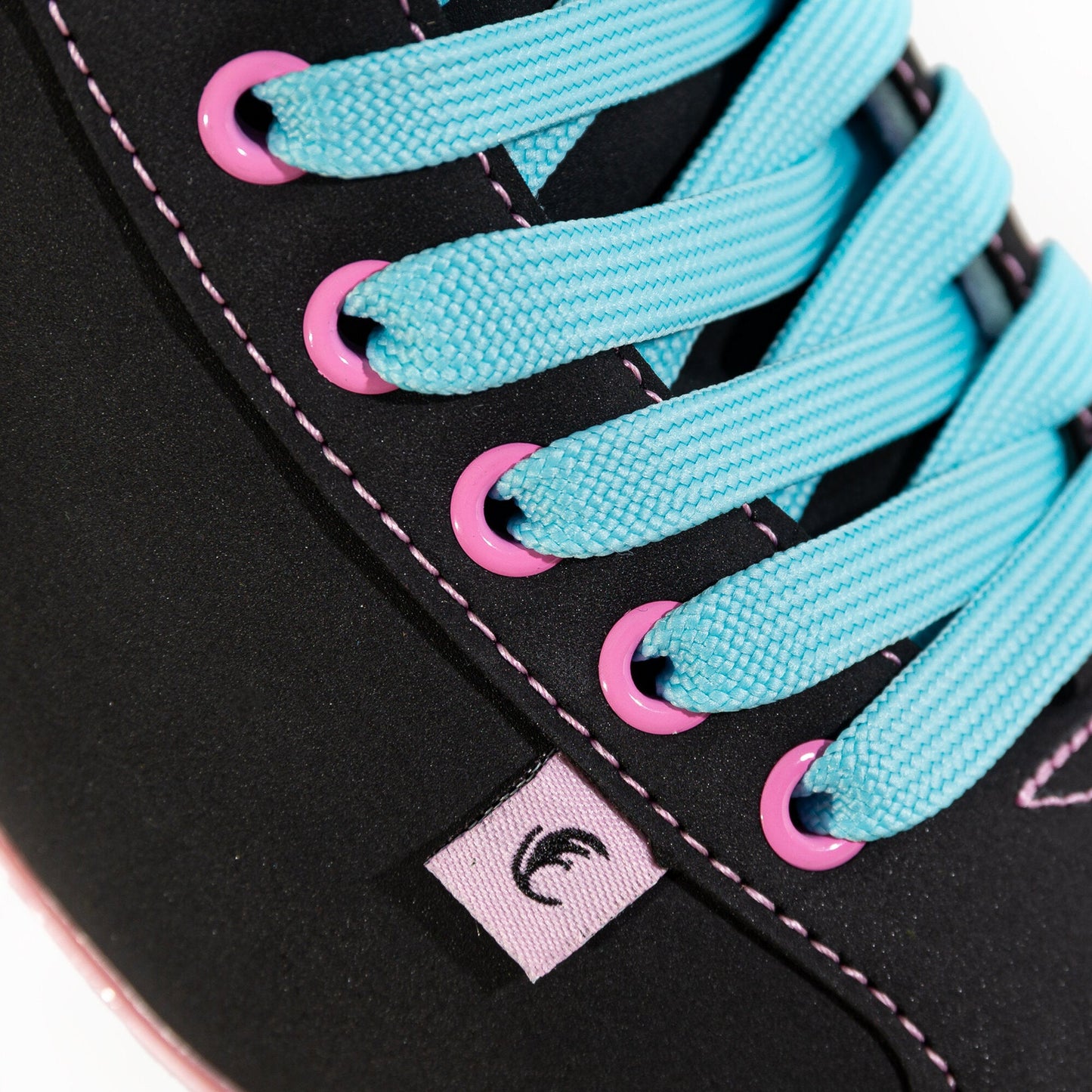 Detailed shot of the blue laces on a Chaya Melrose Black Pink roller skate, contrasting with the black and pink boot.