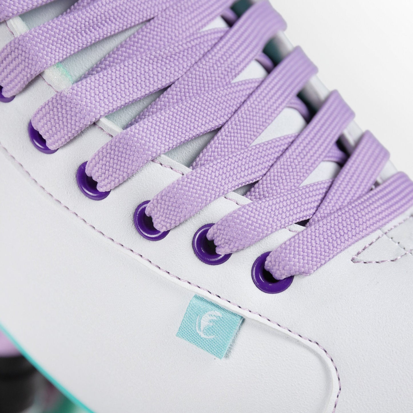 A close-up on the laces of a Chaya Melrose White skate, neatly woven, subtly complementing the boot's pristine finish.