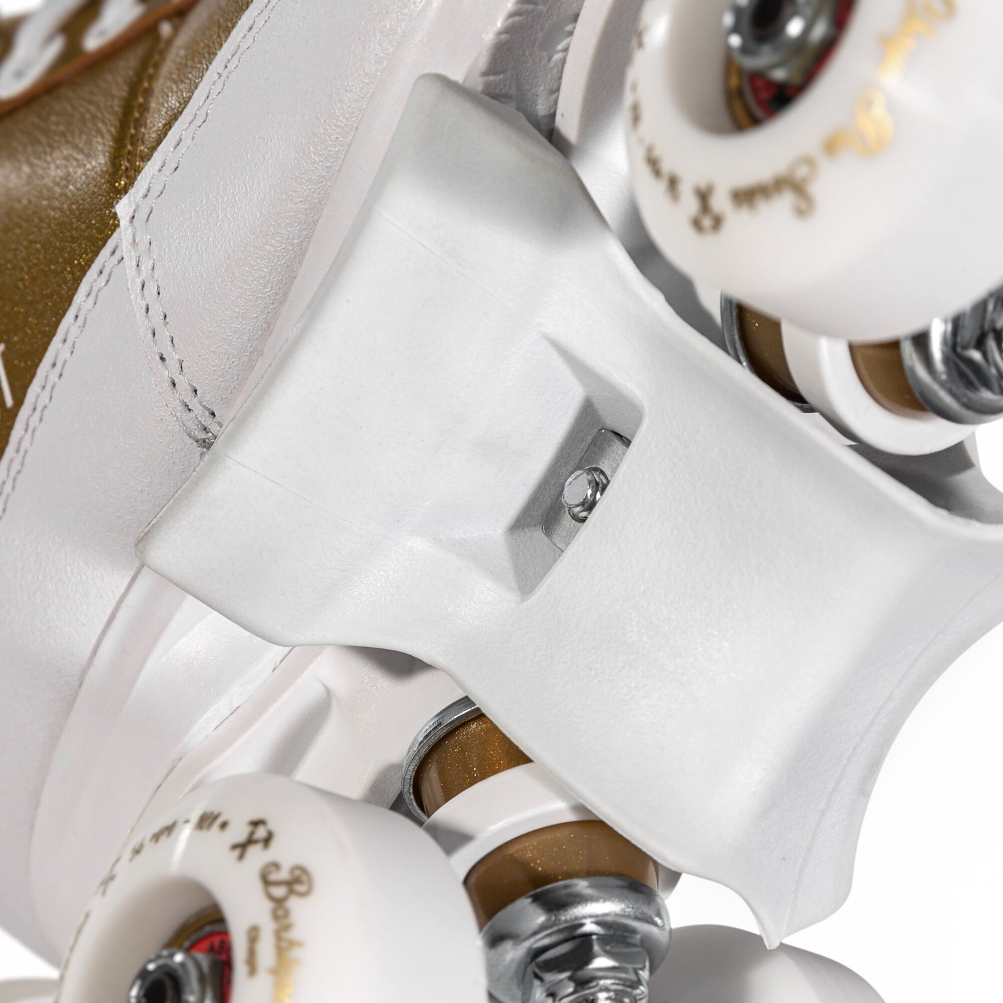 Close-up of the grind block on the Chaya Kismet Barbiepatin Gold roller skate, highlighting its design and material.
