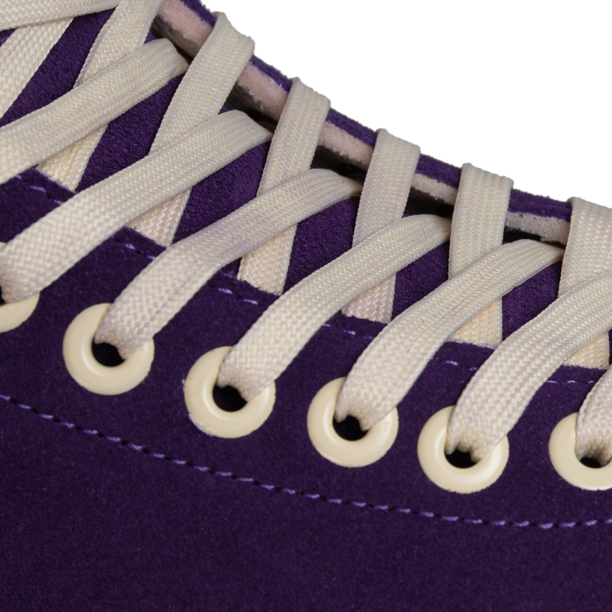 Close-up on the laces of a Chaya Melrose Elite Purple Evil skate, showing their secure arrangement against the dark boot.