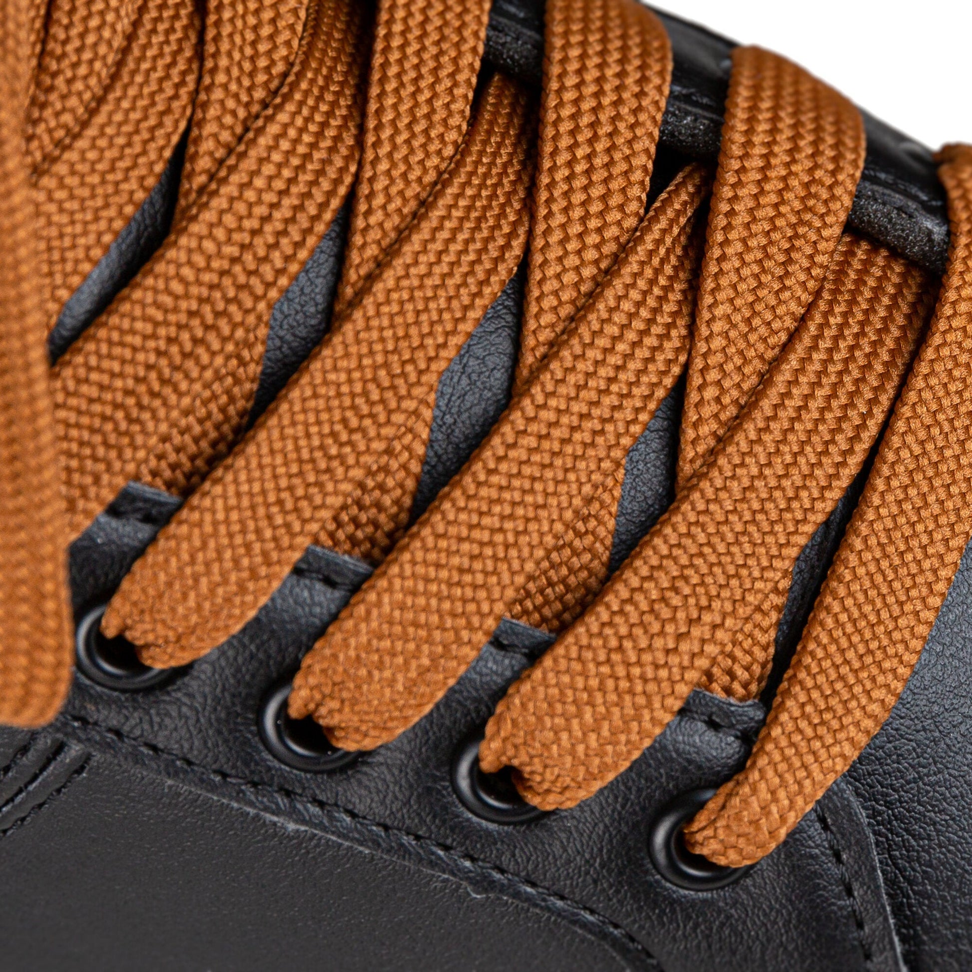 Close-up on the laces of the Chaya Mocha skate, showing their tight weave and how they secure the black boot.