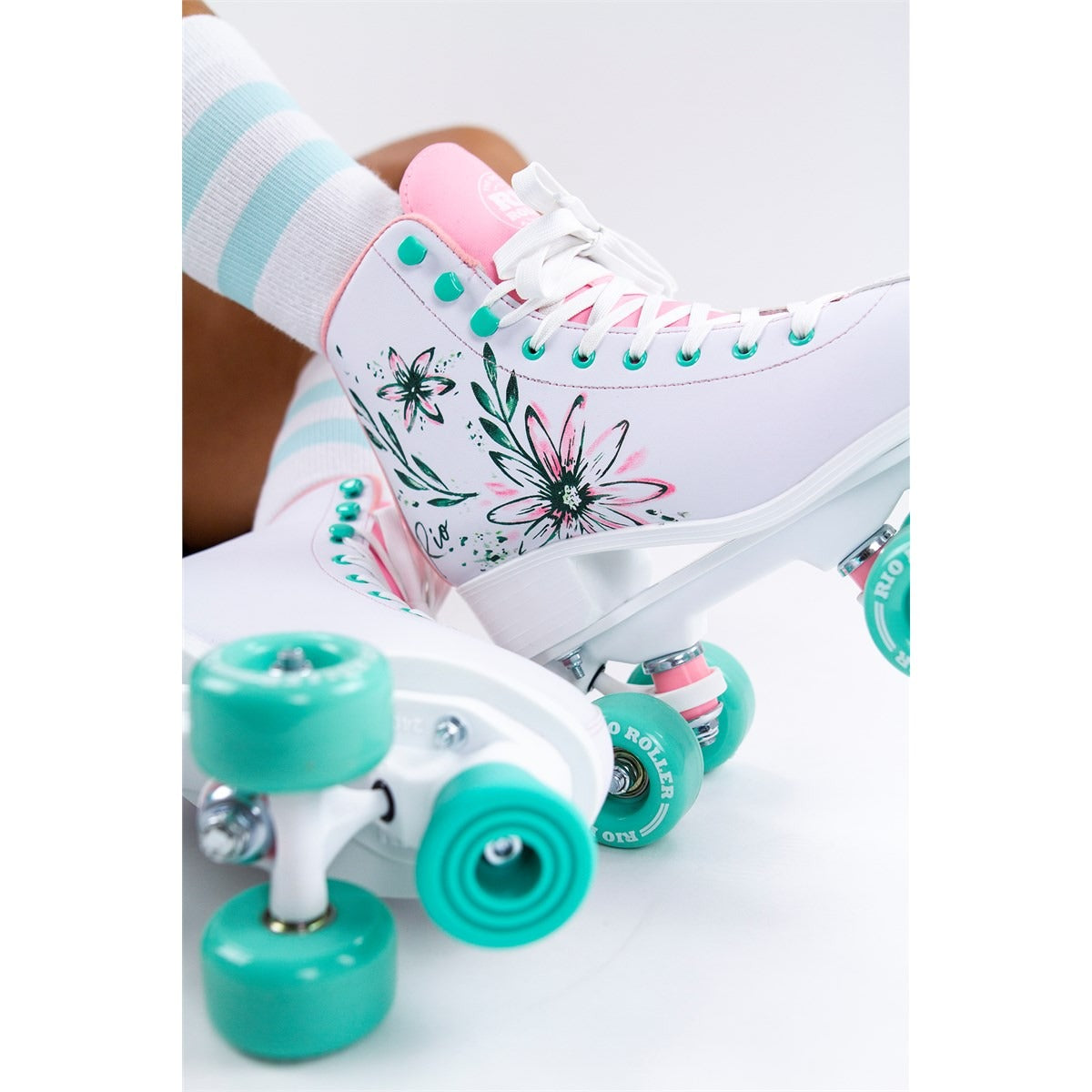 A person wearing the vibrant Rio Roller Artist skates on their feet, showcasing the snug fit and stylish look on a clean white background